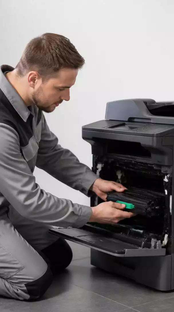 Technician servicing Brother office printer